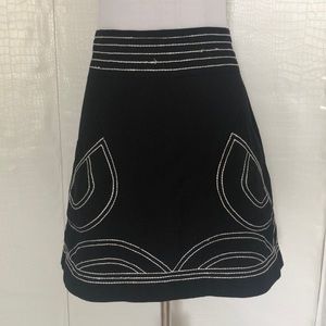 STITCHES OUT A. LINE SKIRT.